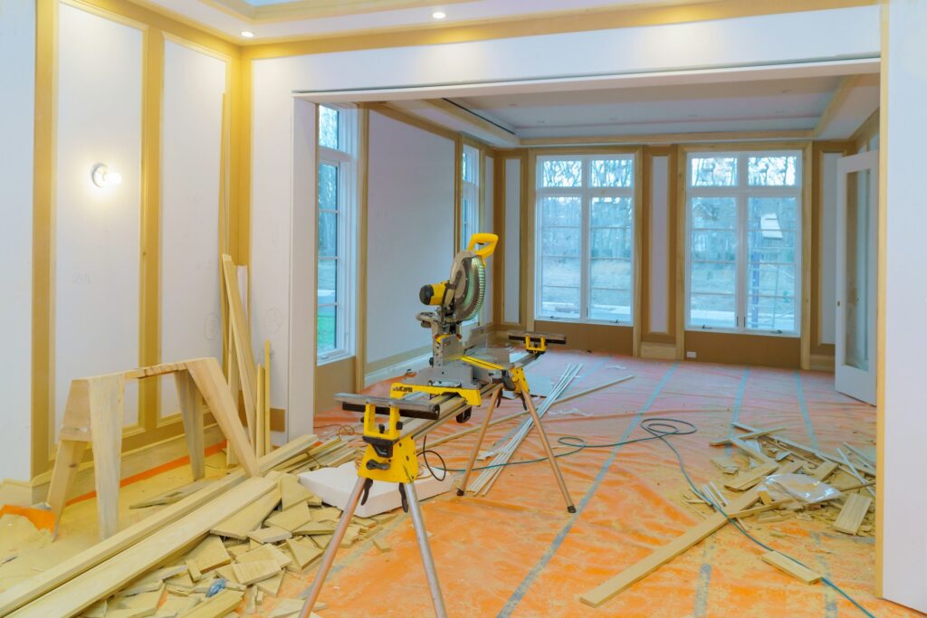 Construction remodeling home with close up of circular saw cutting wood trim molding